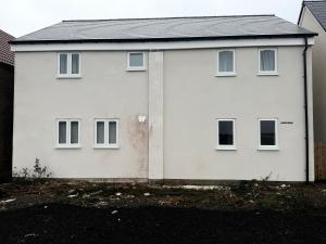 a white house with a row of windows at Cherry Barn Haven in Wisbech Saint Mary