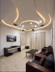 a living room with two couches and a tv at Shalimar Villa-2 in Jāmb