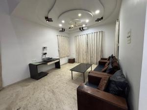 a living room with a couch and a table at Shalimar Villa-2 in Jāmb +2 photos