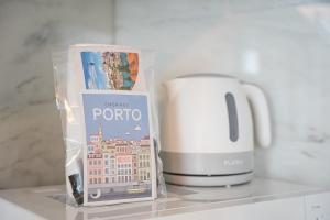 a kitchen counter with a coffee maker and a toaster at GuestReady - Charming cosy home in Porto +26 photos