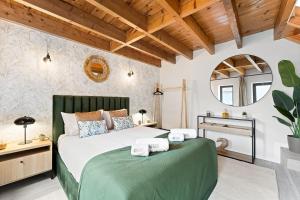 a bedroom with a green bed and a mirror at GuestReady - Charming cosy home in Porto