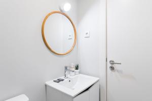 a bathroom with a sink and a mirror at GuestReady - Charming cosy home in Porto