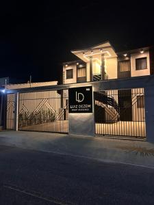 a building with a fence with a sign on it at LD Smart Residence in Castanhal