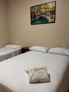 a hotel room with two beds and a bag on the bed at LD Smart Residence in Castanhal