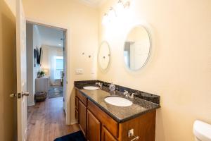 a bathroom with two sinks and two mirrors at Ocean View l Pet Friendly in Gilchrist +31 photos