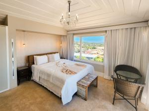 a bedroom with a large bed and a large window at Pousada Ao Por do Sol in Búzios +166 photos