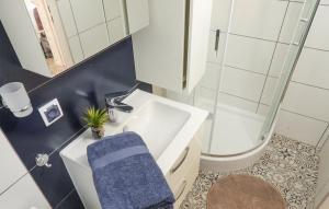 a bathroom with a sink and a toilet and a mirror at z widokiem na zalew in Sułomino