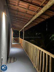 a wooden walkway leading to a building at night at Suites Fernandes Fortim in Fortim
