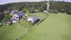 an aerial view of a large house on a green field at z widokiem na zalew in Sułomino +31 photos