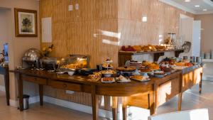 a buffet with many different types of food on a table at Hotel Gramado Interlaken in Gramado