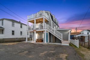 a house with a staircase on the side of it at Salisbury Surf Pet Friendly 1 Block to Beach in Salisbury