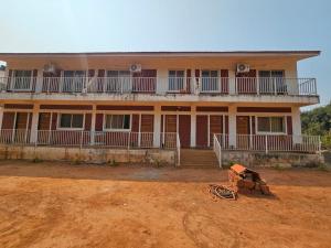 a large house with a dirt field in front of it at Zen Villa in Murūd