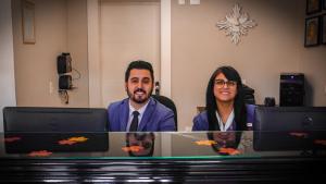 a man and a woman sitting in front of computers at Hotel Gramado Interlaken in Gramado