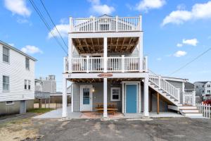 a white house with a staircase on it at Salisbury Sol Pet Friendly Private Balconies in Salisbury