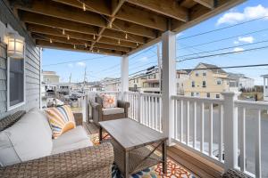a porch with a couch and a table on a balcony at Salisbury Sol Pet Friendly Private Balconies in Salisbury