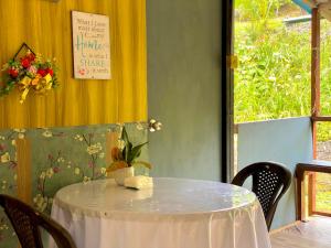 a table in a restaurant with a white table cloth at DA Family Mini Garden in Ranau