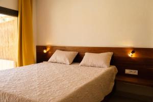 a bedroom with a bed with two pillows on it at Sama Lodge in Saly Portudal +31 photos