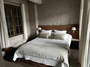 a bedroom with a large bed and a window at De Waterzooi Suites in Ghent