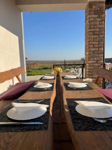 a long wooden table with plates and napkins on it at Kuća za odmor ,,Valvero’’ in Vrbanja
