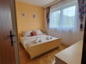 a bedroom with a bed and a large window at Apartment Sea View in Karlobag