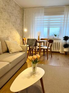 a living room with a couch and a table at Vabaduse apartment in Võru