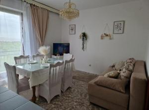 a living room with a table and a couch at Apartment Sea View in Karlobag