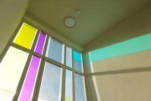 a room with a rainbow stained glass window at HUB Apartments in Hamburg