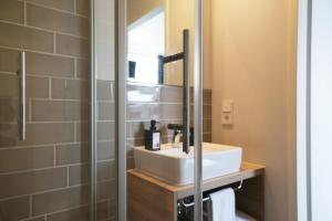 a bathroom with a sink and a mirror at HUB Apartments in Hamburg +36 photos