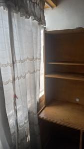 a closet with a window and a curtain at Cuarto por candelaria 2026 in Puno