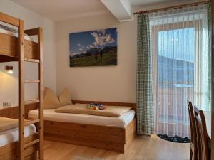 a bedroom with a bunk bed and a window at Bauernhof Ober in Birnbaum