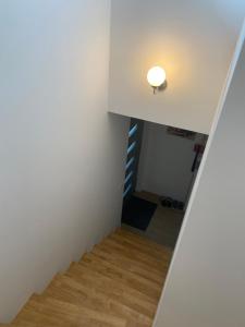 a stairway leading up to a room with white walls at Ruhige Gästehaus AVOLli in Mellach
