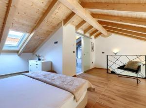 a bedroom with a large bed and wooden ceilings at Apartments Zanet & Niccolo in Fažana