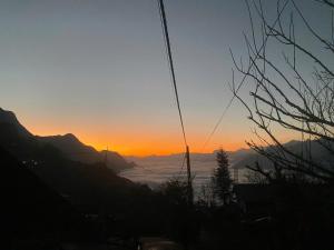 a view of the sun setting over the mountains at Friendly Homestay & Authentic Trekking Tours in Sapa