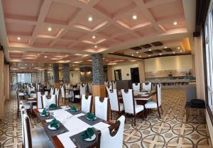 a restaurant with tables and chairs in a room at The Z Retreat & Spa - Swimming Pool & Free Parking - Near Tashi ViewPoint in Gangtok
