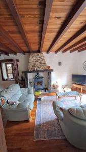 a large living room with couches and a fireplace at Maison Saint Romain in Saulgond