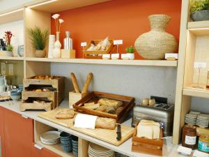 a shelf filled with lots of different types of bread at Résidence les Dômes par Vy Resort Thermal & Spa in Vichy