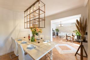 a dining room with a table and white chairs at Apartmant with Pool 8 in Kaštela