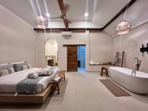 a bedroom with a tub and a bed and a bath room at Haad Yao Bayview Resort & Spa - SHA plus Certified in Haad Yao +37 photos
