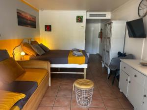 a small room with two beds and a couch at Studio Saint Vincent 13 Non PMR in Sainte-Luce