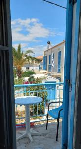 a table and a chair on a balcony with a view at Pension Panagiota in Spetses