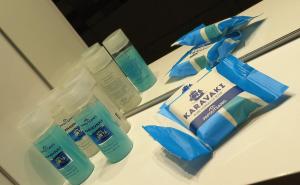 a bathroom counter with two bottles of toothpaste and tooth paste at Pension Panagiota in Spetses