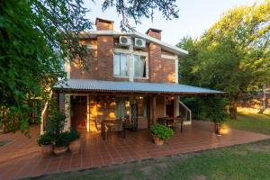 a brick house with a patio in front of it at Cabañas Ocho Soles in Las Rabonas
