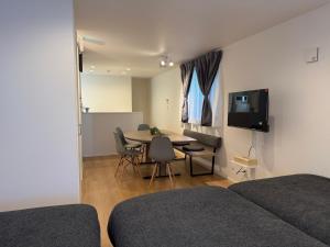 a bedroom with a table and a dining room at 蔵 The KURA in Urayasu