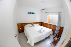 a bedroom with a bed with two candles on it at Hi Adventure in Florianópolis
