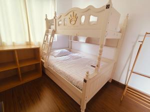 a bedroom with a bunk bed with a ladder at Setia Alam Urban Rooms in Shah Alam