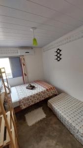 a bedroom with two beds and a ladder in it at Casa da Piscina in Maceió