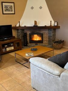 a living room with a couch and a fireplace at Mas del Bot in Valderrobres