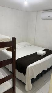 a bedroom with two bunk beds in a room at Hotel Santiago Juazeiro in Juazeiro do Norte