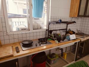 a kitchen counter with a stove and a window at Setia Alam Urban Rooms in Shah Alam