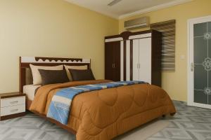 a bedroom with a large bed in a room at CJ Apartment in Kasoa